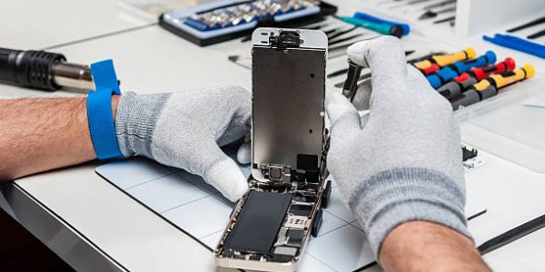 Technician replacing the screen of a used smartphone